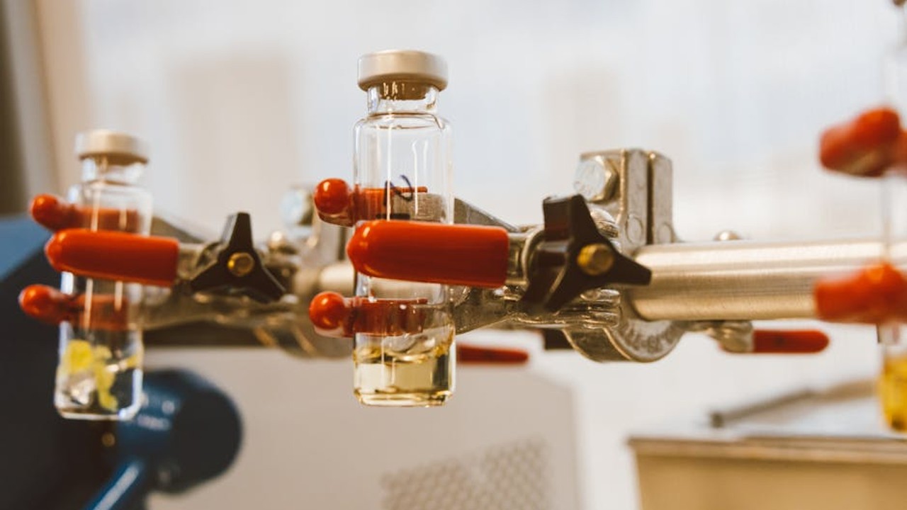 Close-up of a vial containing a clear liquid, representing peptide research and administration.