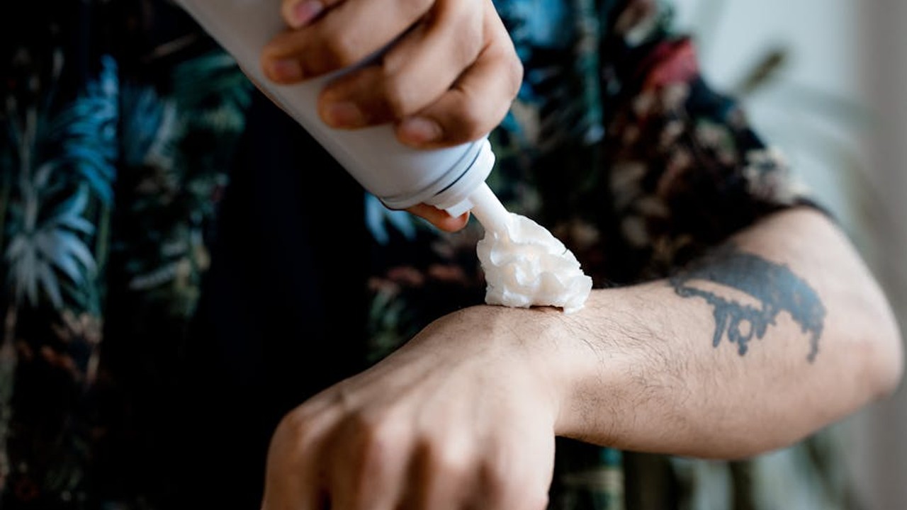 Close-up of a person applying a nasal spray device
