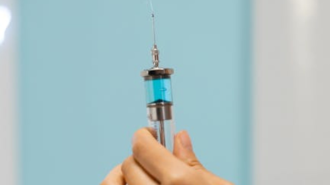A close-up of a syringe containing a clear liquid, representing the administration of injectable peptides.
