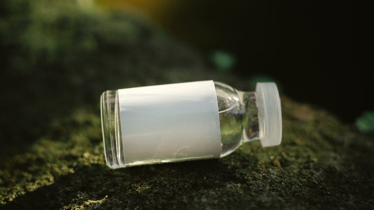 A close-up of a vial containing a clear liquid, representing peptide therapy.
